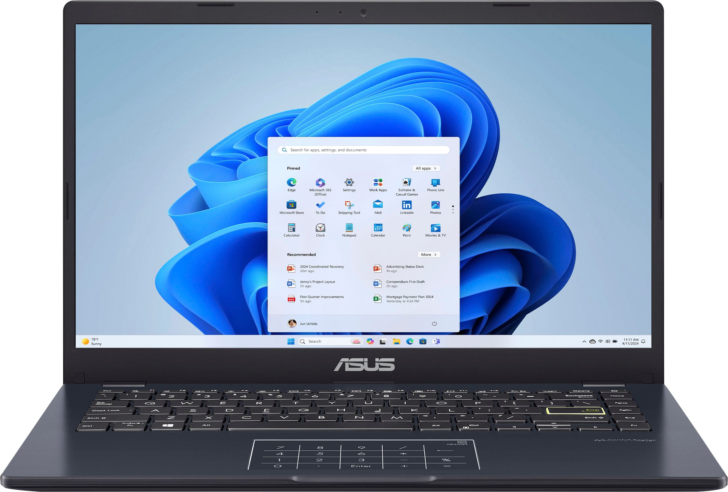 ASUS 14 FHD Laptop displaying a web browser on a desk